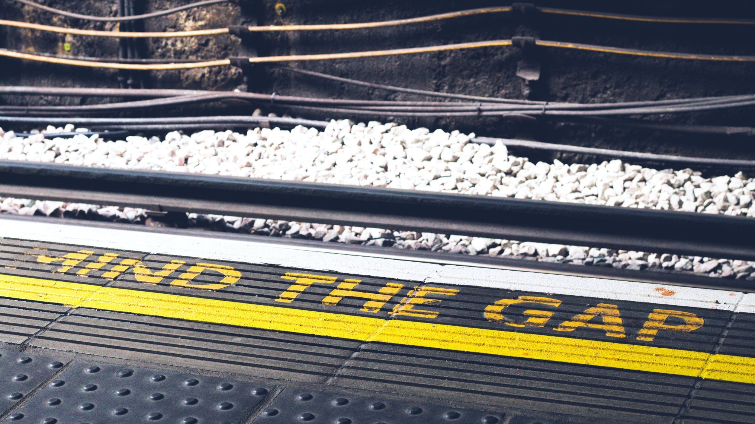 Train platform showing the words “Mind the Gap” at the platform edge
